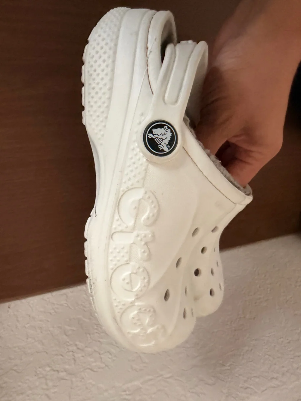 white Crocs Baya Lined Clogs featuring a cozy grey faux-fur lining. C-12